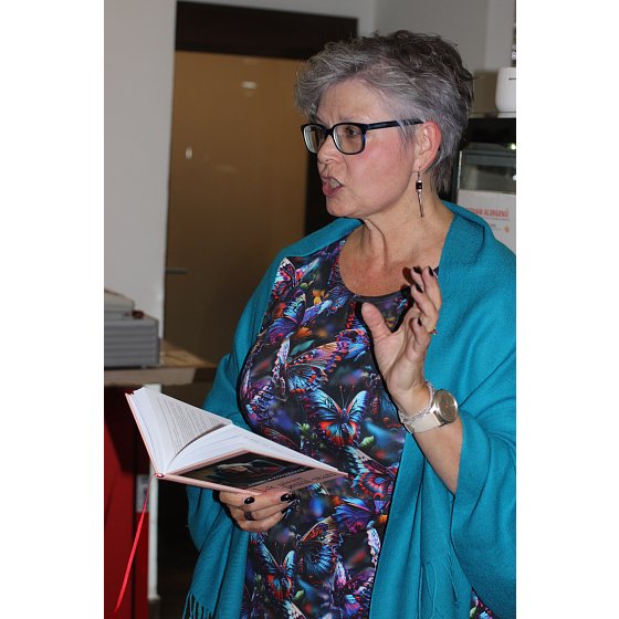 D. čte ze své knihy